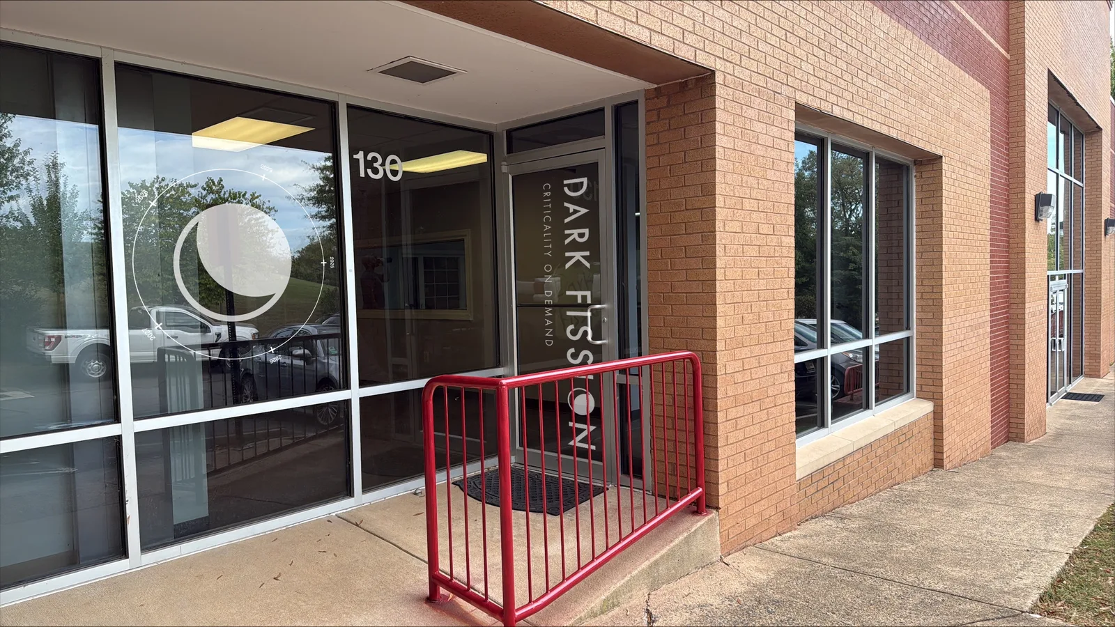 Dark Fission laboratory entrance at Oakbrook Court in Sterling, Virginia, with the Dark Fission logo on the glass